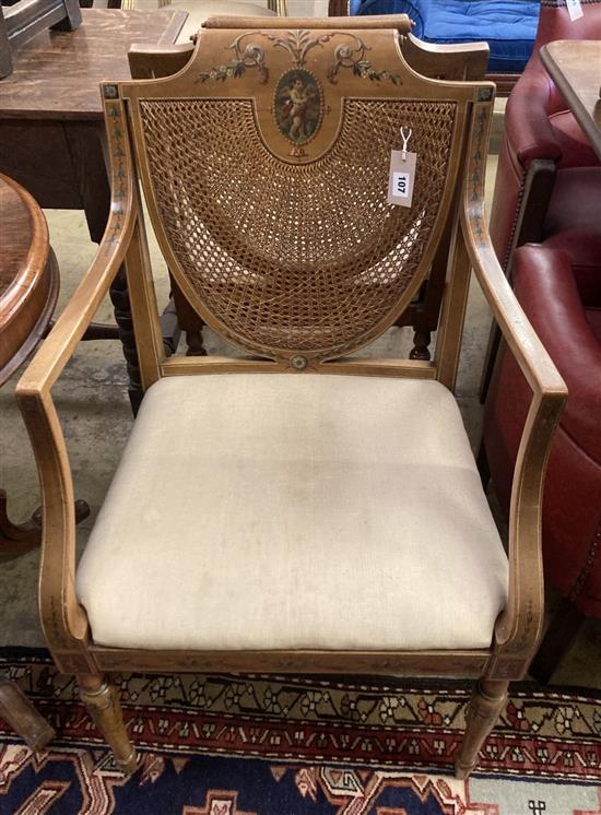A pair of Edwardian Sheraton revival painted satinwood caned back elbow chairs, width 53cm, height 89cm